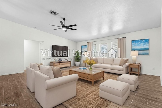 living room with baseboards, vaulted ceiling, visible vents, ceiling fan, and wood finished floors