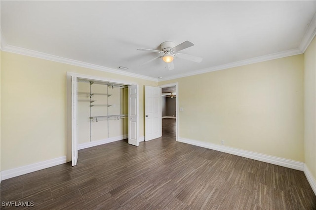 unfurnished bedroom with baseboards, ornamental molding, a closet, and wood finished floors