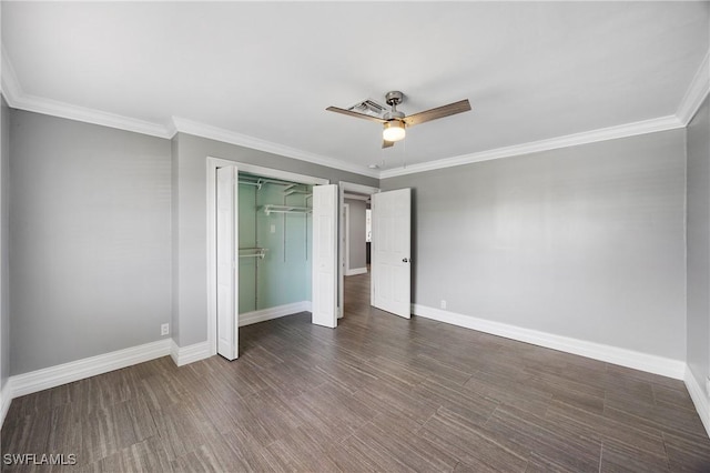 unfurnished bedroom with ornamental molding, a closet, baseboards, and wood finished floors