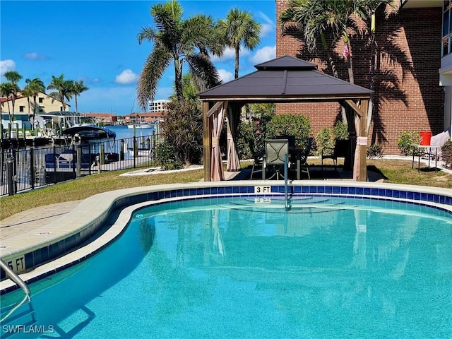 pool with a gazebo, a patio area, and fence