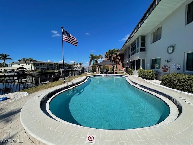 view of pool featuring fence and a gazebo