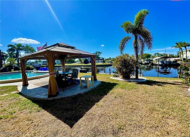 exterior space with a water view, a yard, a patio area, and a gazebo