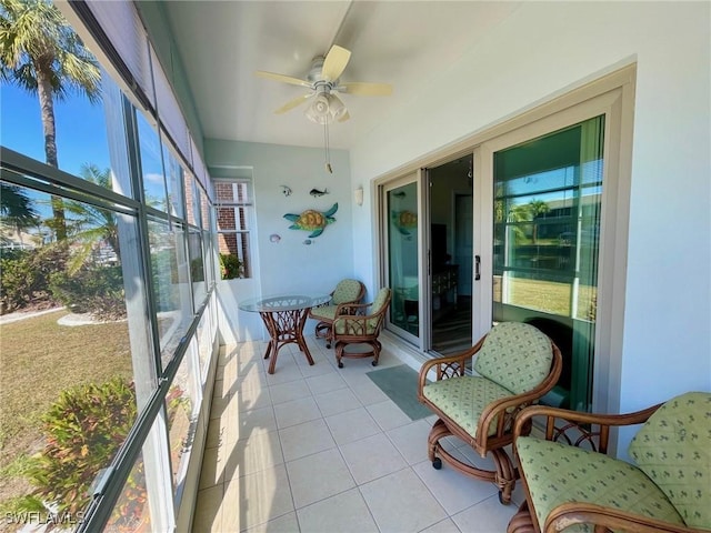 sunroom featuring ceiling fan