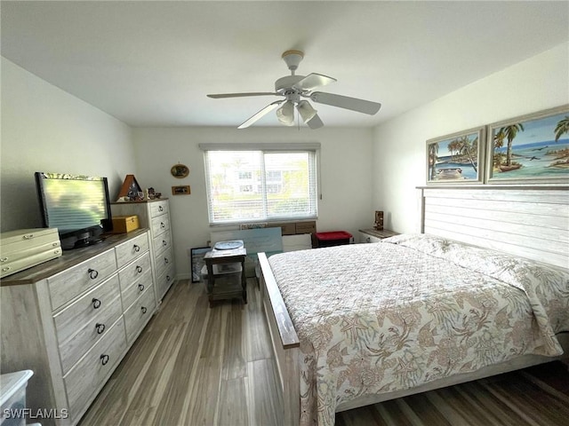 bedroom with a ceiling fan and dark wood finished floors