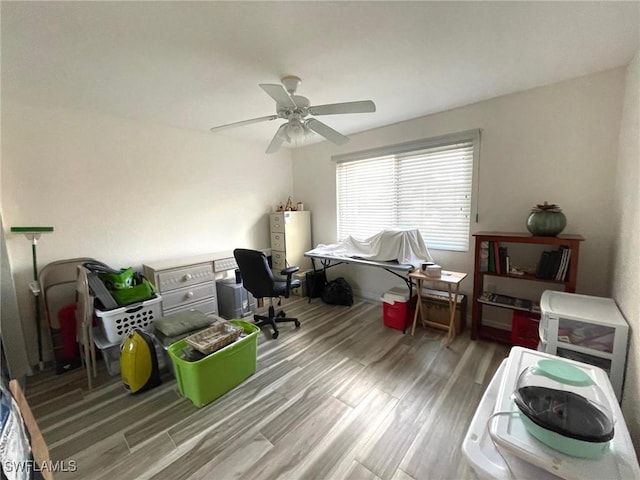 home office with ceiling fan and wood finished floors