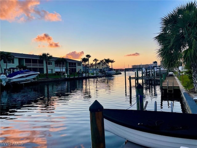 dock area featuring a water view and a residential view