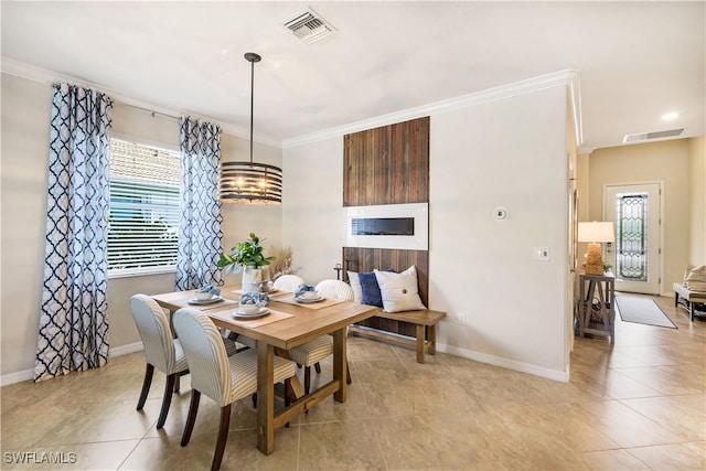 dining space with ornamental molding, visible vents, and baseboards