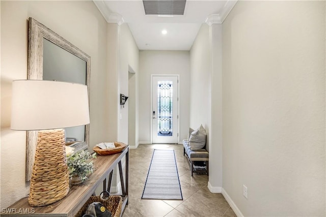 doorway featuring tile patterned flooring, visible vents, and baseboards