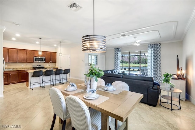 dining space featuring ornamental molding, visible vents, ceiling fan, and baseboards