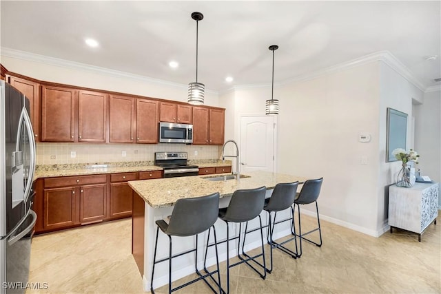 kitchen with decorative backsplash, light stone counters, ornamental molding, stainless steel appliances, and a sink