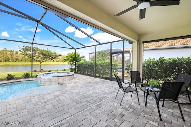 exterior space with a water view, a pool with connected hot tub, a lanai, and a ceiling fan