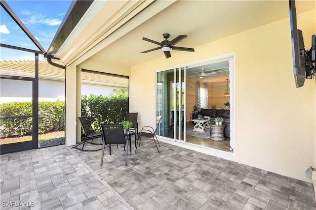 view of patio featuring a lanai and ceiling fan