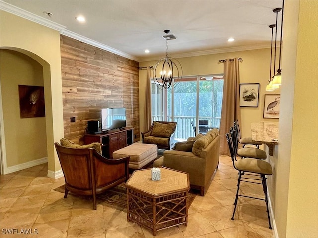 living area with arched walkways, wood walls, an accent wall, and crown molding