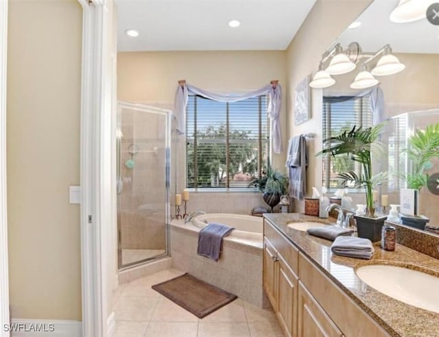 bathroom featuring a sink, a garden tub, a shower stall, and tile patterned floors