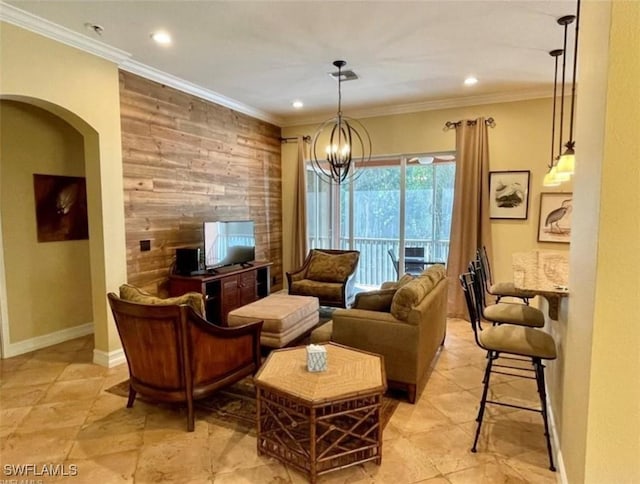 living room featuring an accent wall, crown molding, wooden walls, and arched walkways