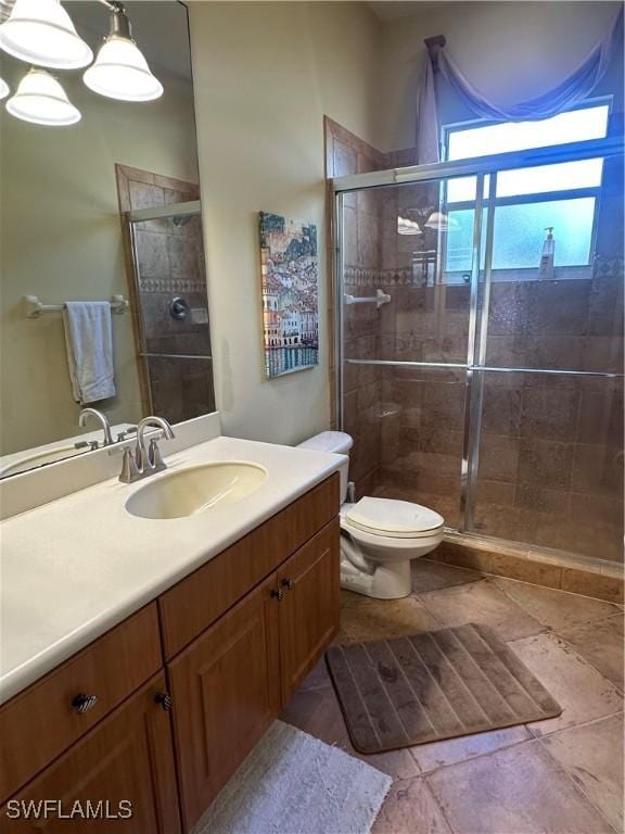 full bathroom with toilet, a stall shower, and vanity