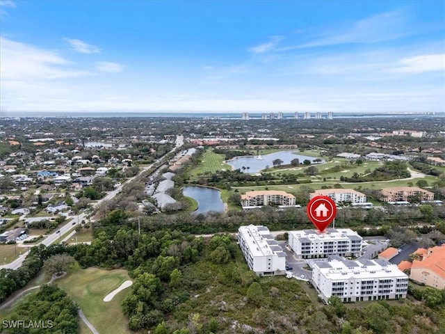 drone / aerial view featuring a water view and a view of city