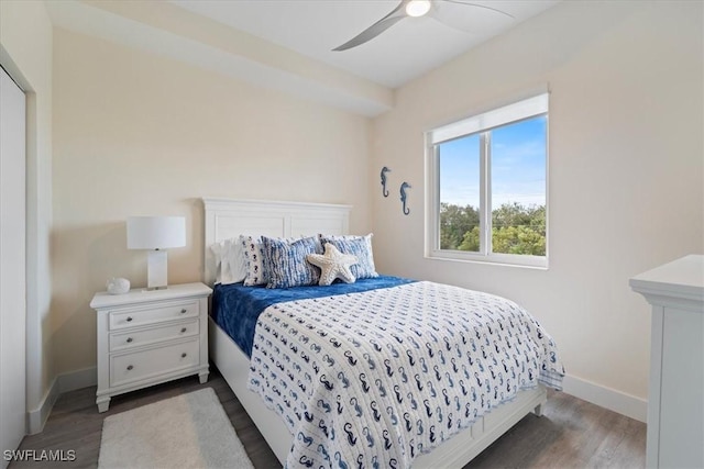 bedroom featuring dark wood-style floors, baseboards, and a ceiling fan