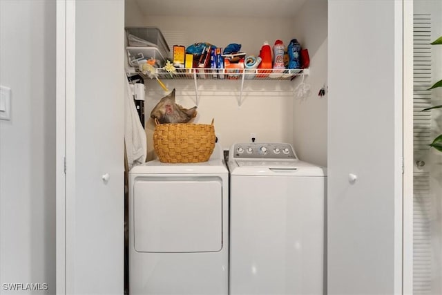 clothes washing area featuring laundry area and washer and clothes dryer