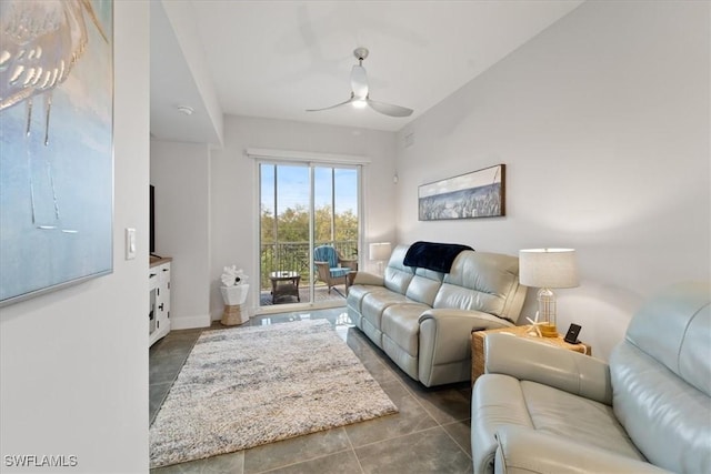 living area with ceiling fan, baseboards, and tile patterned floors