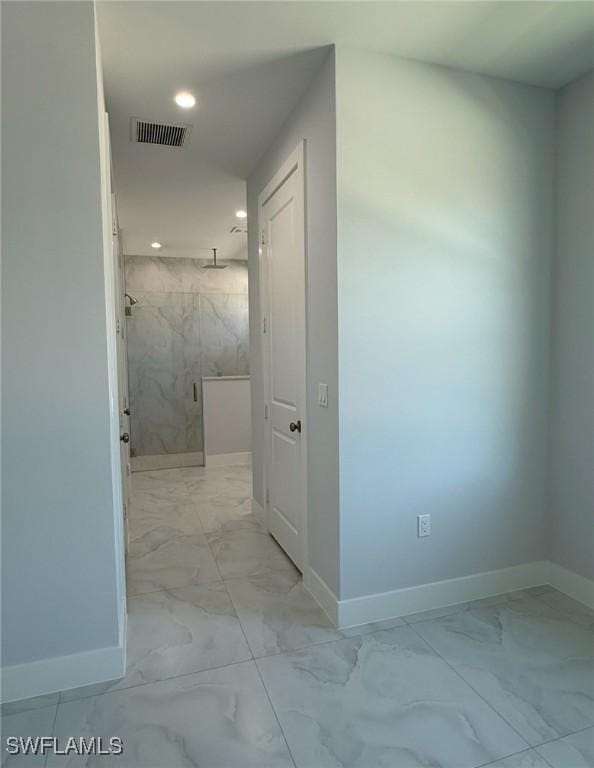 hall featuring marble finish floor, visible vents, and baseboards