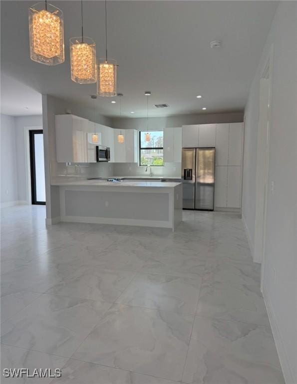 kitchen with marble finish floor, stainless steel appliances, light countertops, white cabinets, and modern cabinets