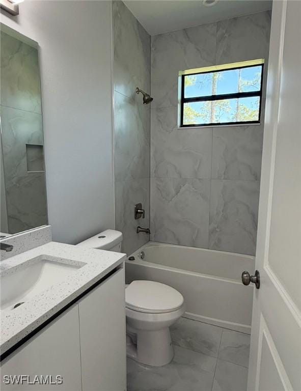 full bathroom with toilet, marble finish floor, tub / shower combination, and vanity