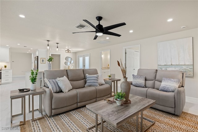 living room with recessed lighting, visible vents, ceiling fan, and baseboards