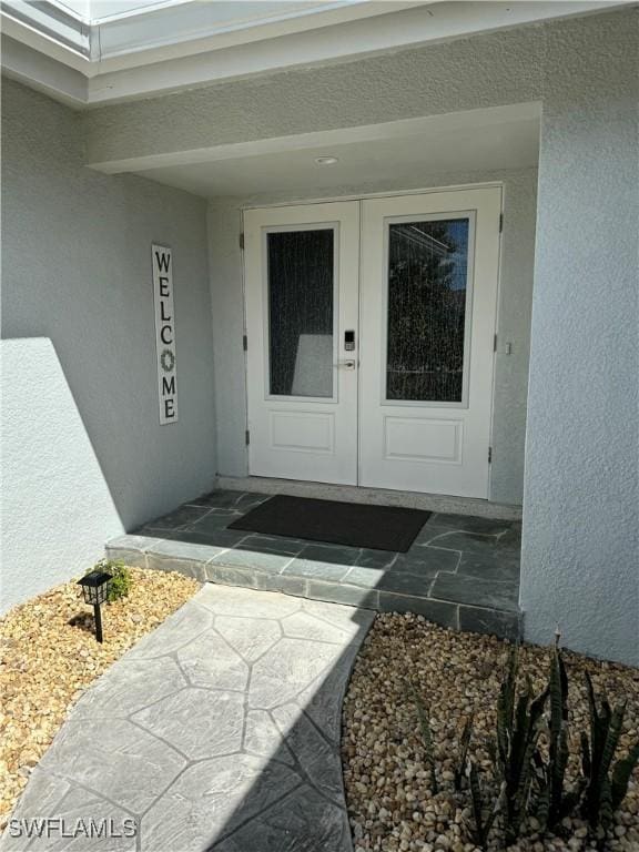 property entrance with stucco siding