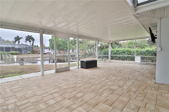 unfurnished sunroom featuring a water view