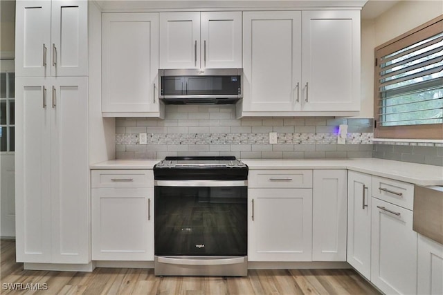 kitchen with white cabinetry, appliances with stainless steel finishes, and light countertops