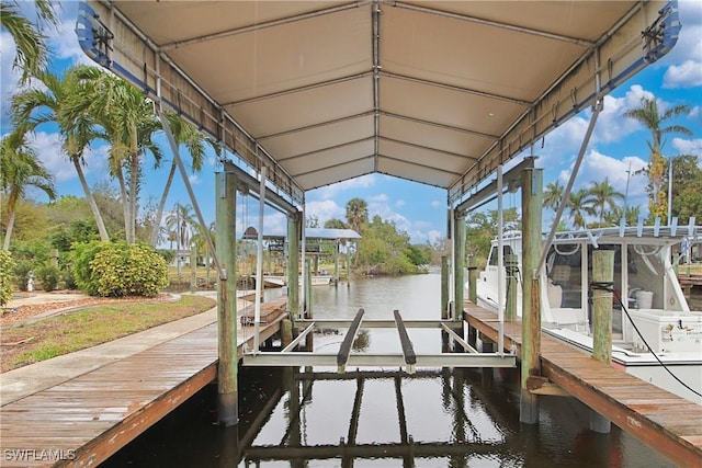 dock area with a water view and boat lift