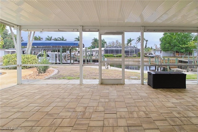 unfurnished sunroom with a healthy amount of sunlight and a water view