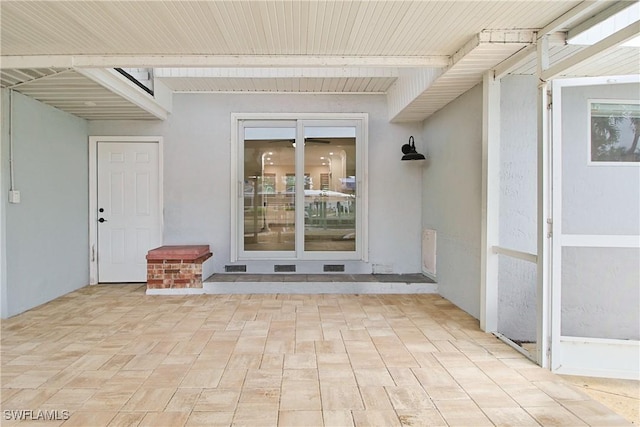 view of exterior entry with stucco siding