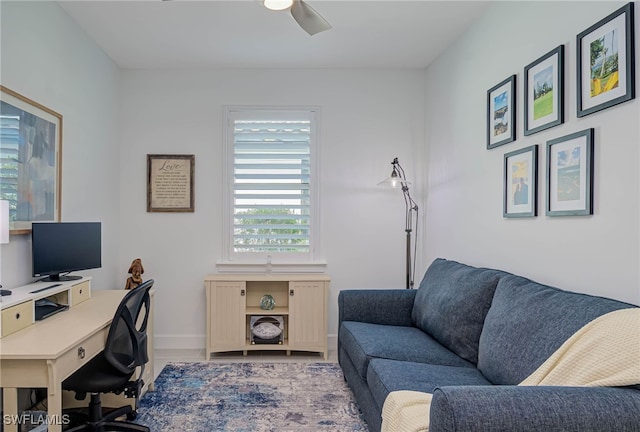 office featuring a ceiling fan and baseboards
