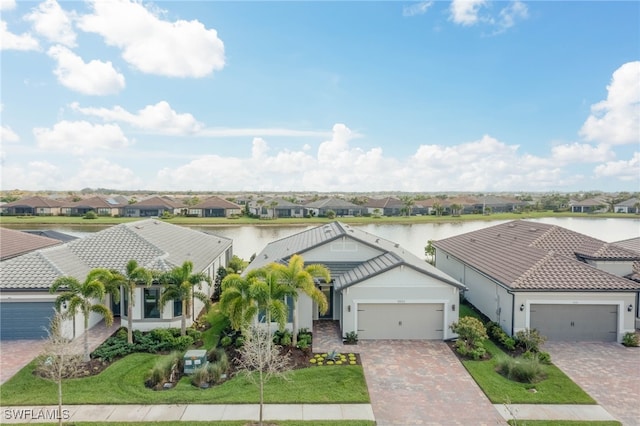 bird's eye view featuring a water view and a residential view