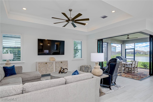 living room with visible vents, a tray ceiling, ceiling fan, and recessed lighting