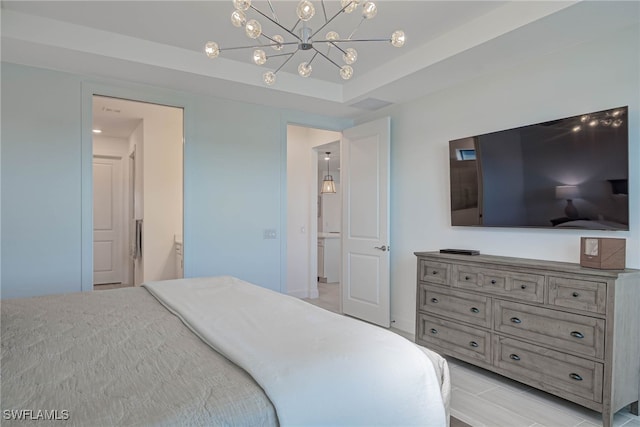 bedroom with a raised ceiling and a notable chandelier