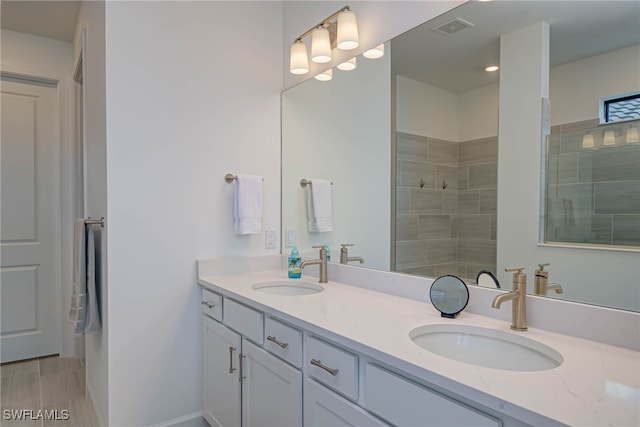 full bathroom with walk in shower, a sink, and visible vents