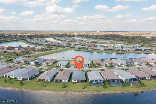 aerial view featuring a residential view and a water view