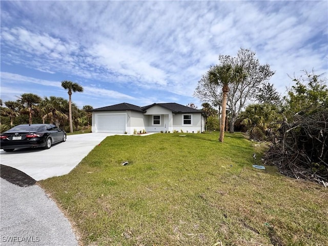 view of front facade featuring a front yard, concrete driveway, and an attached garage