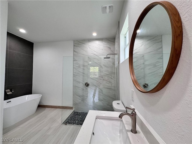 full bath with a marble finish shower, recessed lighting, visible vents, wood finished floors, and a freestanding tub