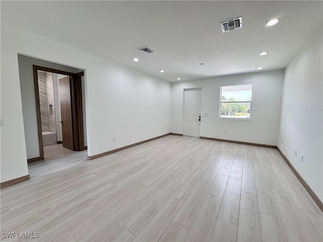 unfurnished room with light wood-style flooring, visible vents, baseboards, and recessed lighting