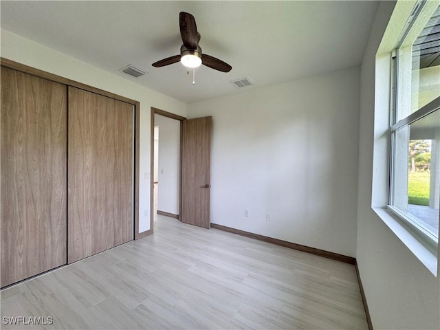 unfurnished bedroom with a ceiling fan, a closet, visible vents, and baseboards