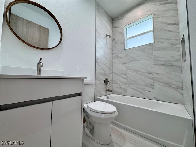 bathroom featuring shower / washtub combination, a textured wall, vanity, and toilet