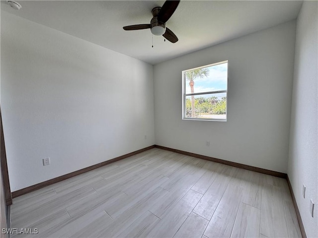 unfurnished room with light wood-type flooring, ceiling fan, and baseboards