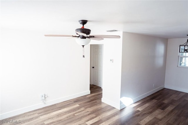 unfurnished room with a ceiling fan, baseboards, visible vents, and wood finished floors