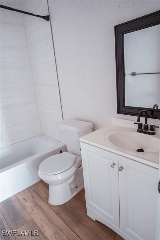 bathroom with shower / tub combination, vanity, toilet, and wood finished floors