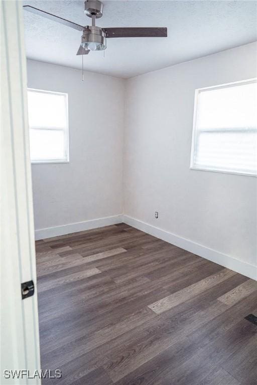 unfurnished room with ceiling fan, baseboards, and wood finished floors