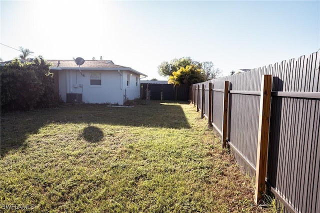 view of yard featuring a fenced backyard and central air condition unit